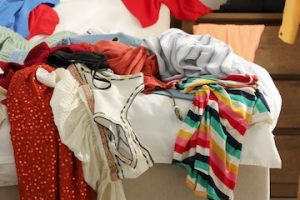 Photos of clothes piled on a bed