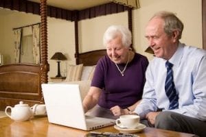 Image of an older man and woman shopping on a computer